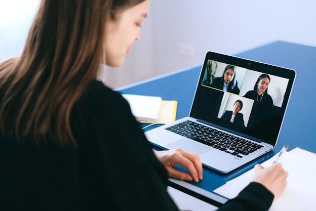 Woman on a Zoom call with three other people.